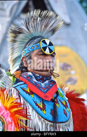 Usa,Native American Mature man wearing ceremonial dress in front of Teepee Stock Photo