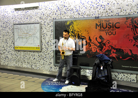 Busker in Canary Wharf Underground Station, Canary Wharf, Greater London, England, United Kingdom Stock Photo