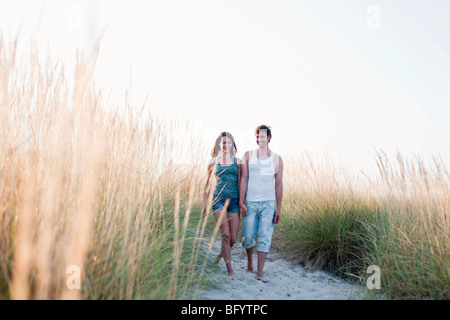 couple strolling along beach Stock Photo