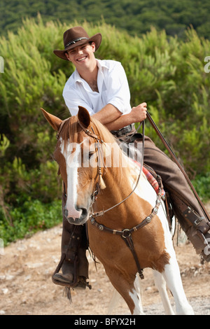 man riding horse smiling Stock Photo