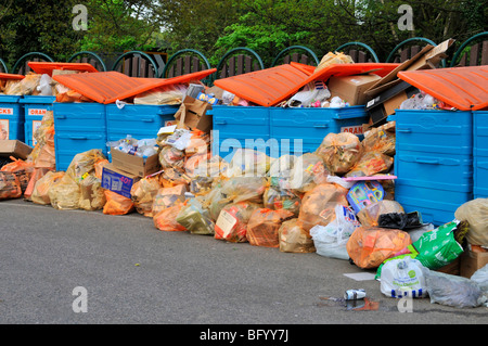 Local council public rubbish & recycling drop off layby overflowing bins where waste management resources failed to keep up with demand England UK Stock Photo