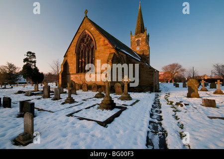 A snowy scene showing the parish church of St Catherine's at Barmby in East Riding of Yorkshire. Stock Photo