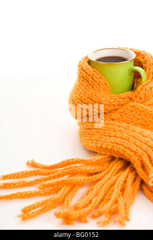 Green mug wrapped yellow scarf isolated on white background Stock Photo