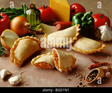 Assorted empanadas on stone with fresh ingredients Stock Photo