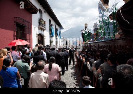 Procession in honour of Virgin Mary during Semana Santa in Antigua Guatemala. Cucuruchos carrying the float on their shoulders. Stock Photo