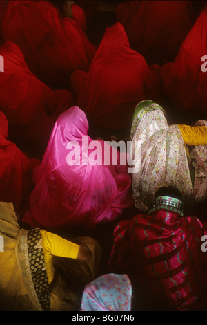 A group of women wearing saris sit and pray and worship in a Hindu temple in the city of Bhuj in the west India state of Gujarat Stock Photo
