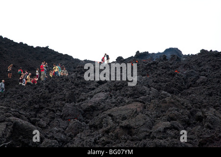 Flowing Lava and Tourists towards the Pacaya Volcano Peak. Volcan Pacaya National Park. Stock Photo