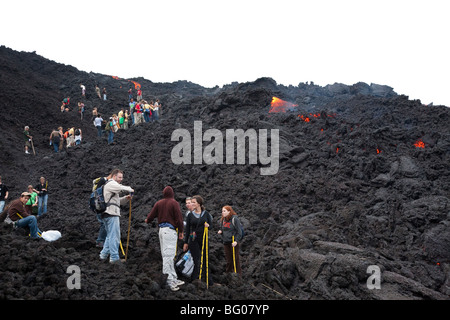 Flowing Lava and Tourists towards the Pacaya Volcano Peak. Volcan Pacaya National Park. Stock Photo