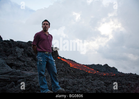 Flowing Lava and Tourist Guide towards the Pacaya Volcano Peak. Volcan Pacaya National Park. Stock Photo