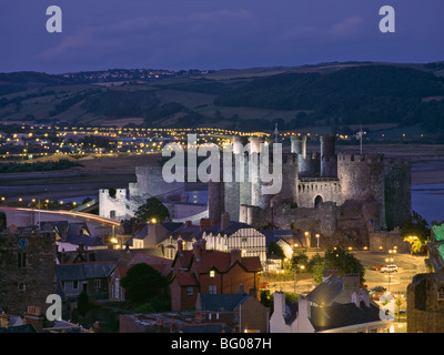 Floodlit Conwy Castle, overlooking the town with the River Conwy estuary beyond at dusk, Gwynedd, North Wales, United Kingdom Stock Photo
