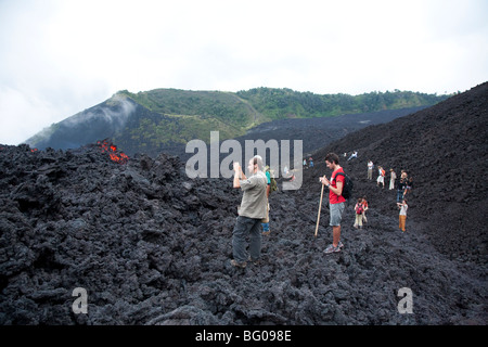 Flowing Lava and Tourists towards the Pacaya Volcano Peak. Volcan Pacaya National Park. Stock Photo