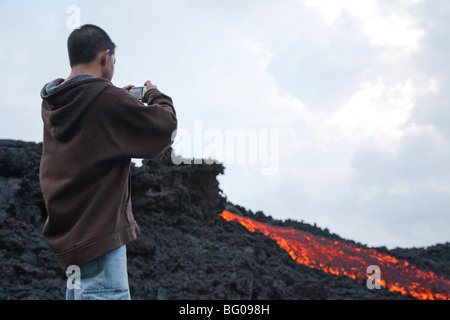 Flowing Lava and Tourists towards the Pacaya Volcano Peak. Volcan Pacaya National Park. Stock Photo