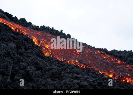 Flowing Lava and Tourists towards the Pacaya Volcano Peak. Volcan Pacaya National Park. Stock Photo