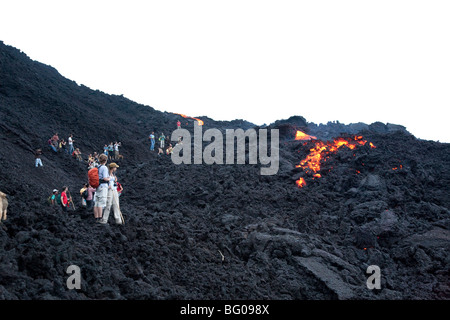 Flowing Lava and Tourists towards the Pacaya Volcano Peak. Volcan Pacaya National Park. Stock Photo