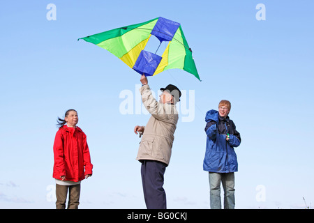 family flying kites Stock Photo