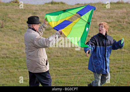 grandfather and grandson flying kites Stock Photo