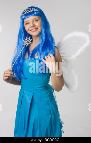 young beautiful girl with long blue hair and in blue dress with magic wand Stock Photo