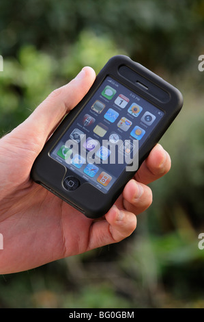 Man's hand operating a iPhone touch screen Stock Photo