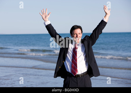 Young businessman enjoying the beach. Stock Photo