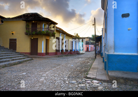 Cobbled street at dusk with brightly painted houses, off Plaza Mayor, Trinidad, Cuba, West Indies, Central America Stock Photo