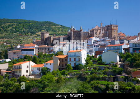 View of village from valley, the Real Monasterio de Santa Maria de Guadalupe prominent, Guadalupe, Caceres, Extremadura, Spain Stock Photo