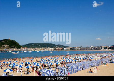 Parasols on the beach and town view, San Sebastian, Basque country, Euskadi, Spain, Europe Stock Photo