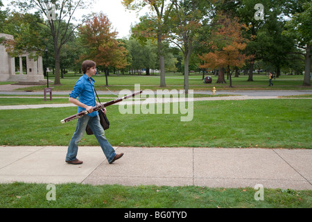 Oberlin, Ohio - Music student Wade Coufal carries his bassoon as he walks across the campus of Oberlin College. Stock Photo