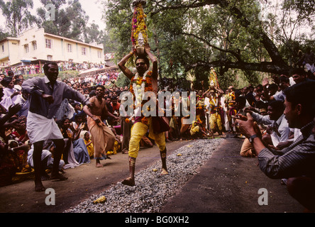 Firewalking in the village of Ketti in the South India state of Tamil Nadu. Fire walking is an important ritual practiced by certain sections of Hindu society. Fire walking is an act of self-purification. For some devotees it is a part of a vow in which the devotee promises to walk on fire in exchange for a wish or blessing granted by Amman. Amman is an important female deity associated with the Shakti cult in South Indian and Tamil culture. Stock Photo