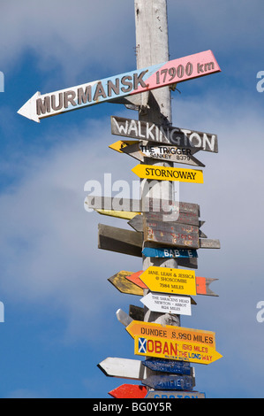Signs with mileage to world destinations made into a totem pole, Port Stanley, Falkland Islands, South America Stock Photo