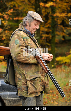 gamekeeper relaxing with his gun Stock Photo