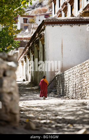 Novice monk, a small boy, walks at Hemis Gompa (Tibetan Buddhist monastery) in Ladakh, India. Stock Photo