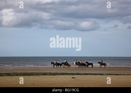 Horse riders on 'Sword Beach', Colleville-Montgomery-Plage near Ouistreham, Normandy, France Stock Photo