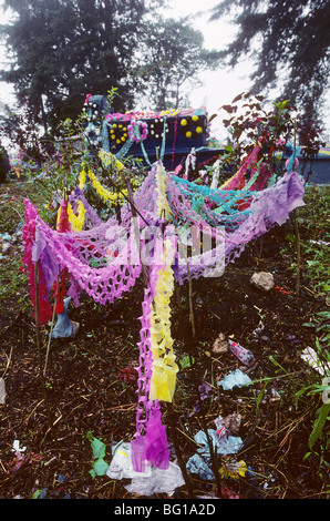 Brightly colored paper streamers are the primary decoration for the graves of the cemetery in San Martin, Guatemala on the Day of the Dead Stock Photo