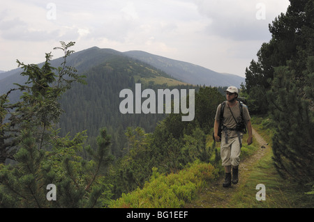 Walker on a footpath near Bocianske sedlo on the way up to Dumbier mountain, the highest in the Low Tatras Stock Photo