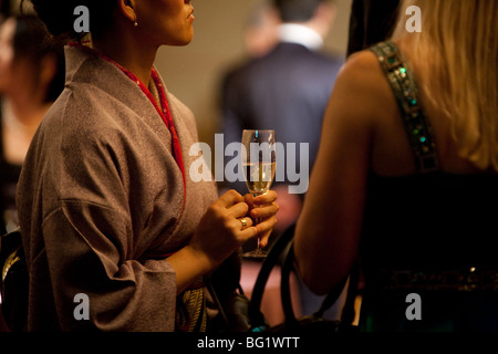 Japanese woman in kimono drinking champagne. Stock Photo