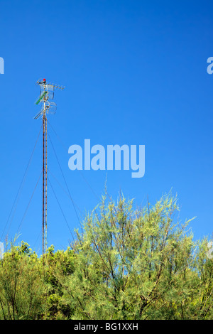 High Antenna against bright blue sky Stock Photo