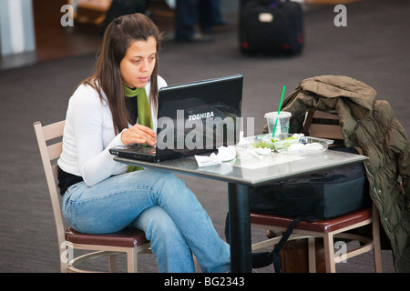 Mexican traveler accessing WIFI internet inside Benito Juarez International Airport in Mexico City Stock Photo