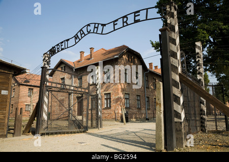 The main entrance – with REAL Arbeit Macht Frei slogan above the gates – at Auschwitz Nazi death camp in Oswiecim, Poland. Stock Photo