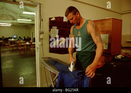 A member of the Fleet Air Arm  Field Gunners team does he ironing t Stock Photo
