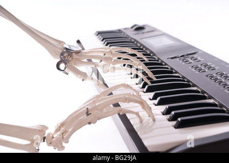 Skeleton playing an electric keyboard with High Key background Stock Photo