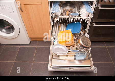 A dishwasher fully loaded with dirty dishes ready to be washed Stock Photo
