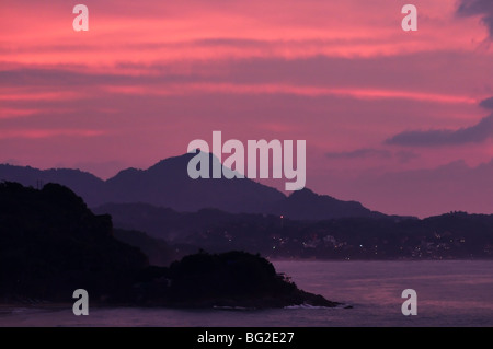 A gorgeous pink sunset washes over Mexico's Riviera Nayarit.  View of Sayulita and the Sierra Madre mountains from San Pancho. Stock Photo