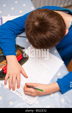 A MODEL RELEASED picture of a ten year old boy doing his maths homework in the Uk