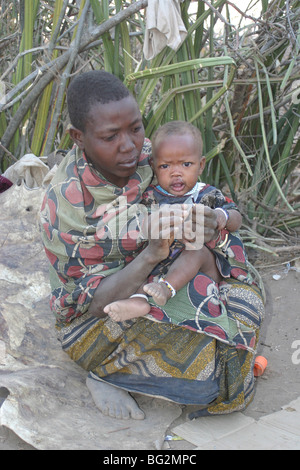 Africa, Tanzania, Lake Eyasi, Portrait of a young Hadza mother with her baby, Stock Photo