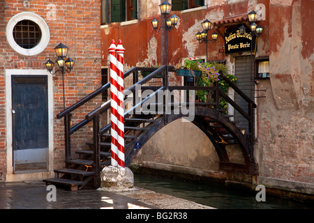 Small foot bridge over canal in Venice Veneto Italy Stock Photo