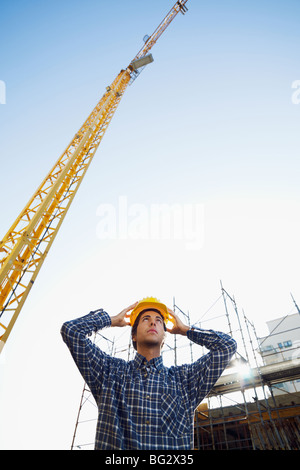 construction worker wearing hard hat. Low angle view, copy space Stock Photo