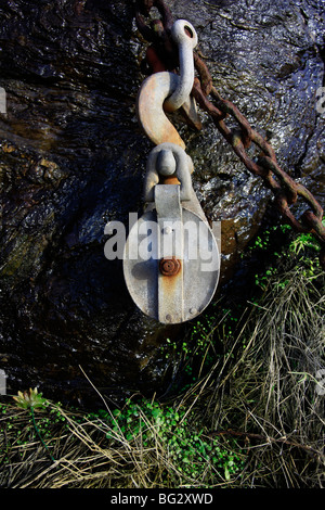 Pulley and chain on harbour wall Cornwall UK Stock Photo
