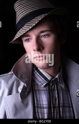 a young trendy man in pensive mood in a low key setting Stock Photo