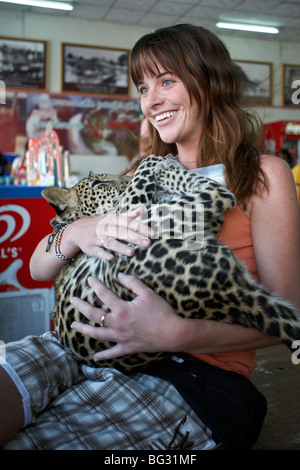 Woman with Leopard cub in her arms at a Thailand centre. S. E. Asia Stock Photo