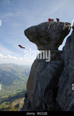 BASE jump from a cliff. The ultimate kick to do an object jump with a tracking suit on and fly proximity down the mountain. Stock Photo